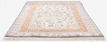 A semi-antique silk Isfahan rug, Central Persia, signed (Sadegh) Seirafian, c. 209 x 142 cm.