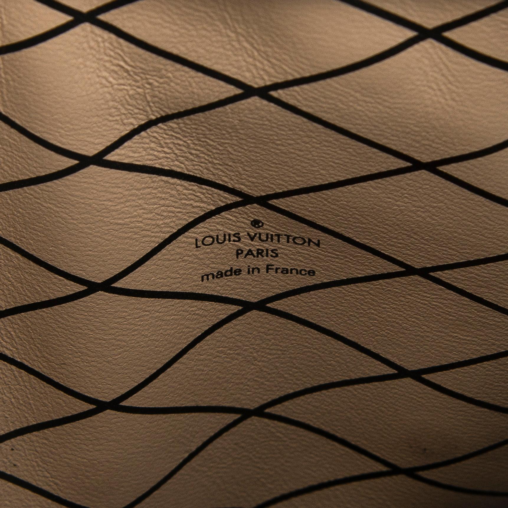 Louis Vuitton, a "Reverse Monogram Trunk Clutch" bag.