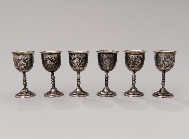 A set of six Persian silver coffee cups with spoons and saucers and six beakers, mid-20th century.