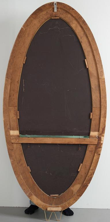 Italian designer, a wall mirror, 1950-60's. Emerald green tinted glass and brass frame.