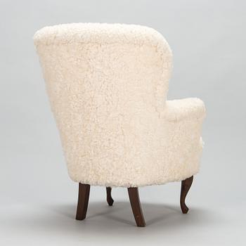 A contemporary sheepskin upholstered lounge chair, ABC collection.