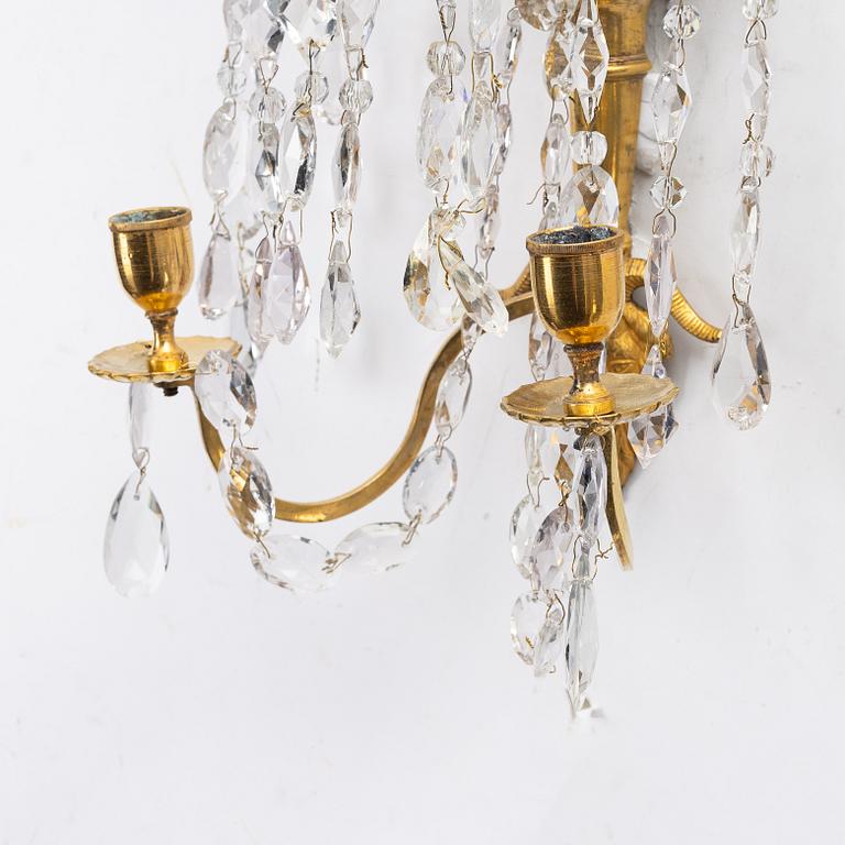 A pair of late Gustavian ormolu two-branch lustres, circa 1800.