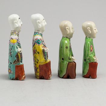 A group of four famille rose figures of laughing boys, late Qing dynasty, 19th Century.