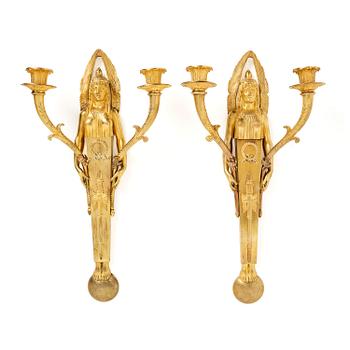 118. A pair of French Empire two-branch ormolu wall lights, early 19th century,.