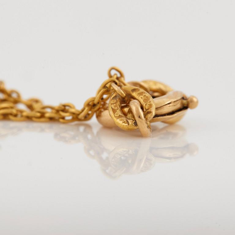 A necklace set with seed pearls, a cabochon cut sapphire, probably another sapphire and filigree work.