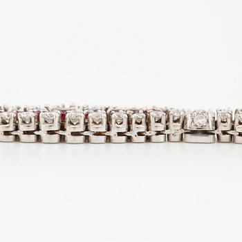 An 18K white gold bracelet set with rubies and round brilliant-cut diamonds.