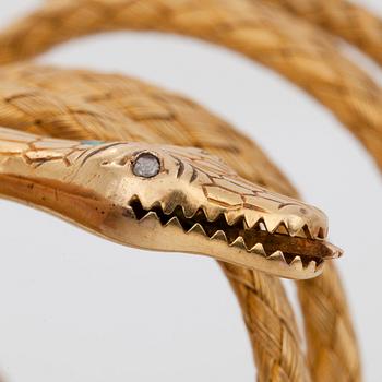 A flexible bracelet. An emerald and rose-cut diamonds on snake head.