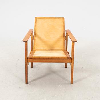 A stained wooden armchair later part of the 20th century.