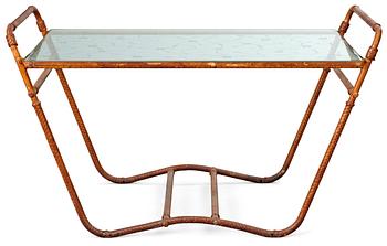 575. A tea table, 1940's-50's, metal frame, covered in brown leather straps, decorated glass top.