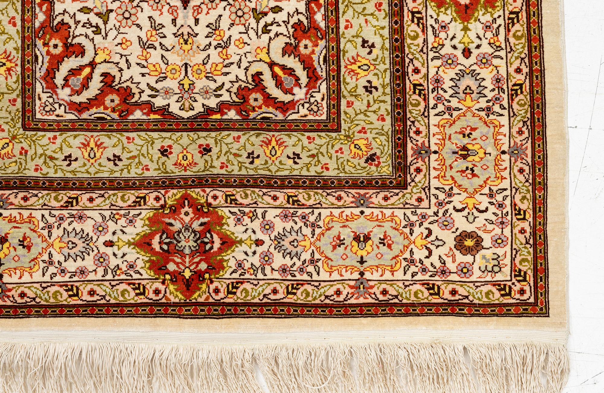 A Hereke silk rug, West Anatolia, c. 107 x 69 cm.