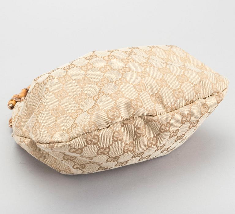 A GUCCI BAG, "STUDDED  BAMBOO HANDLE".
