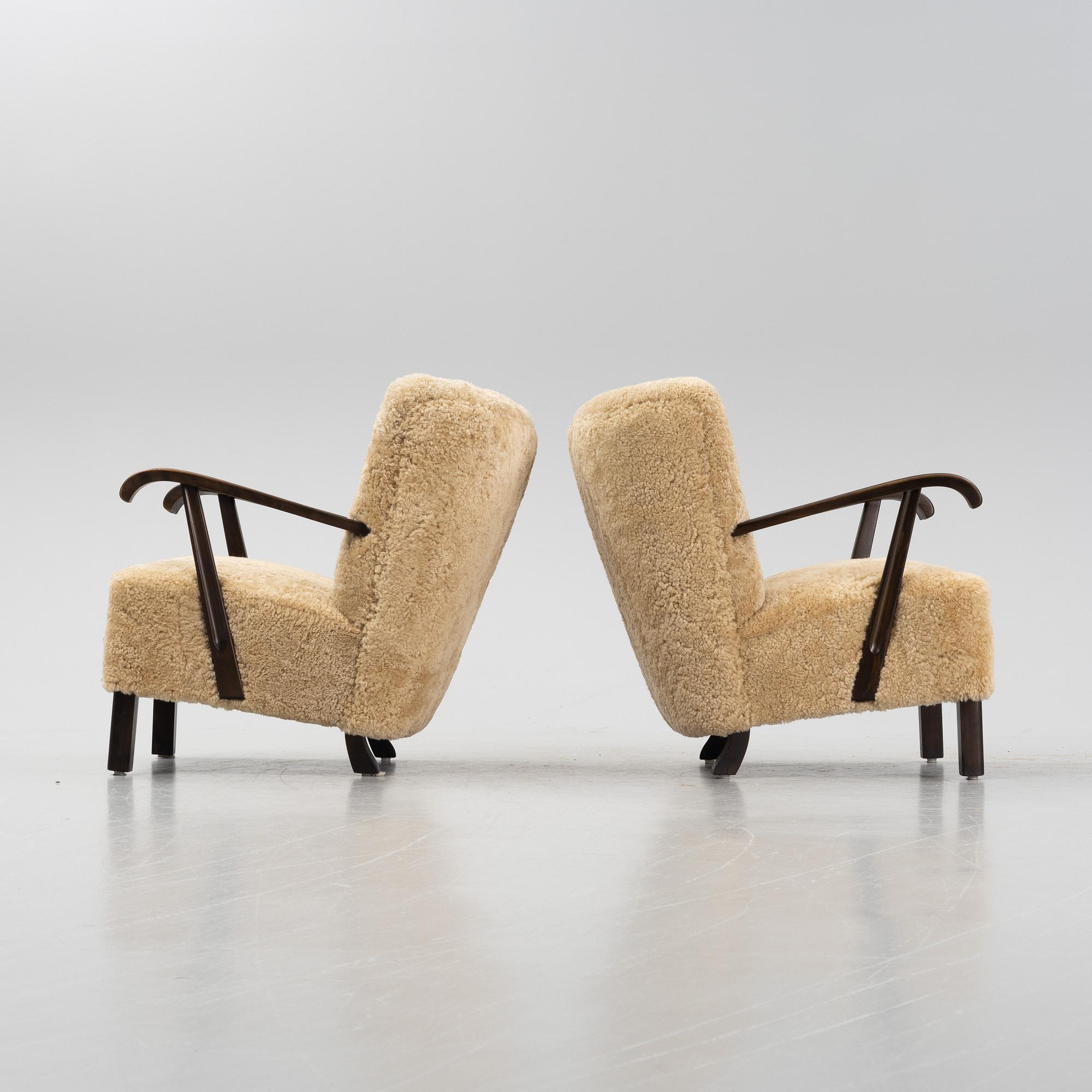 A pair of lounge chairs with new sheepskin upholstery, Denmark, 1930's/40's.