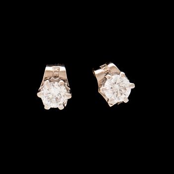 A pair of 18K white gold earrings set with round brilliant cut diamonds.