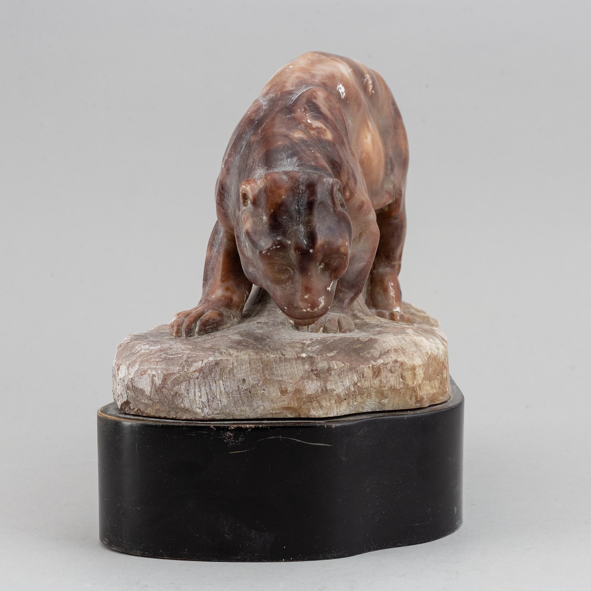 A 20th century stone sculpture of a panther.