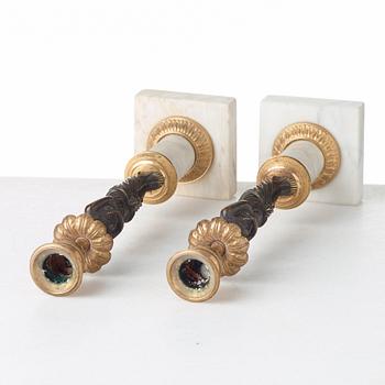 A pair of late Gustavian circa 1800 white marble and bronze candlesticks.