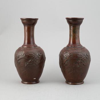 A pair of Japanese copper alloy temple vases, Meiji period (1868-1912).