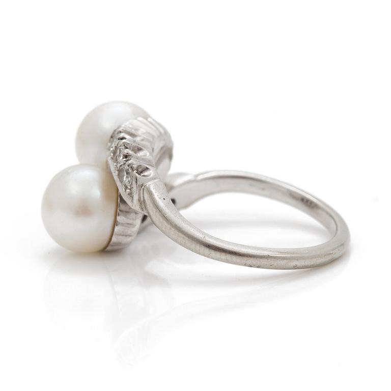 A cross-over ring of two cultured pearls with eight-cut diamonds.