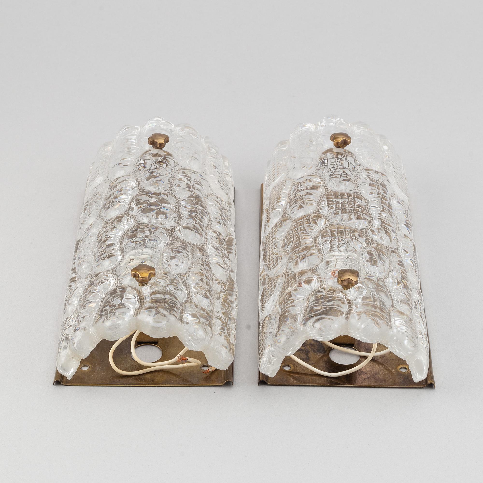 Carl Fagerlund, a pair of glass and brass wall sconces, Orrefors, second half of the 20th Century.
