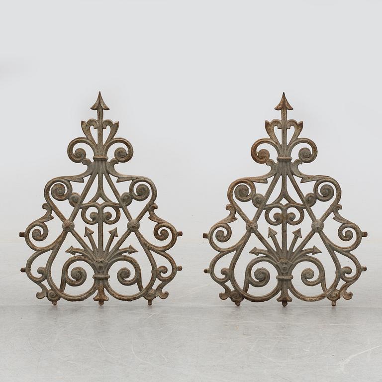 a pair of cast iron decorative pieces from the late 19th century.