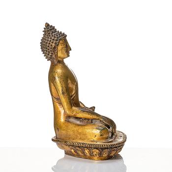 A gilt copper alloy figure of buddha, Nepal, 18th Century.