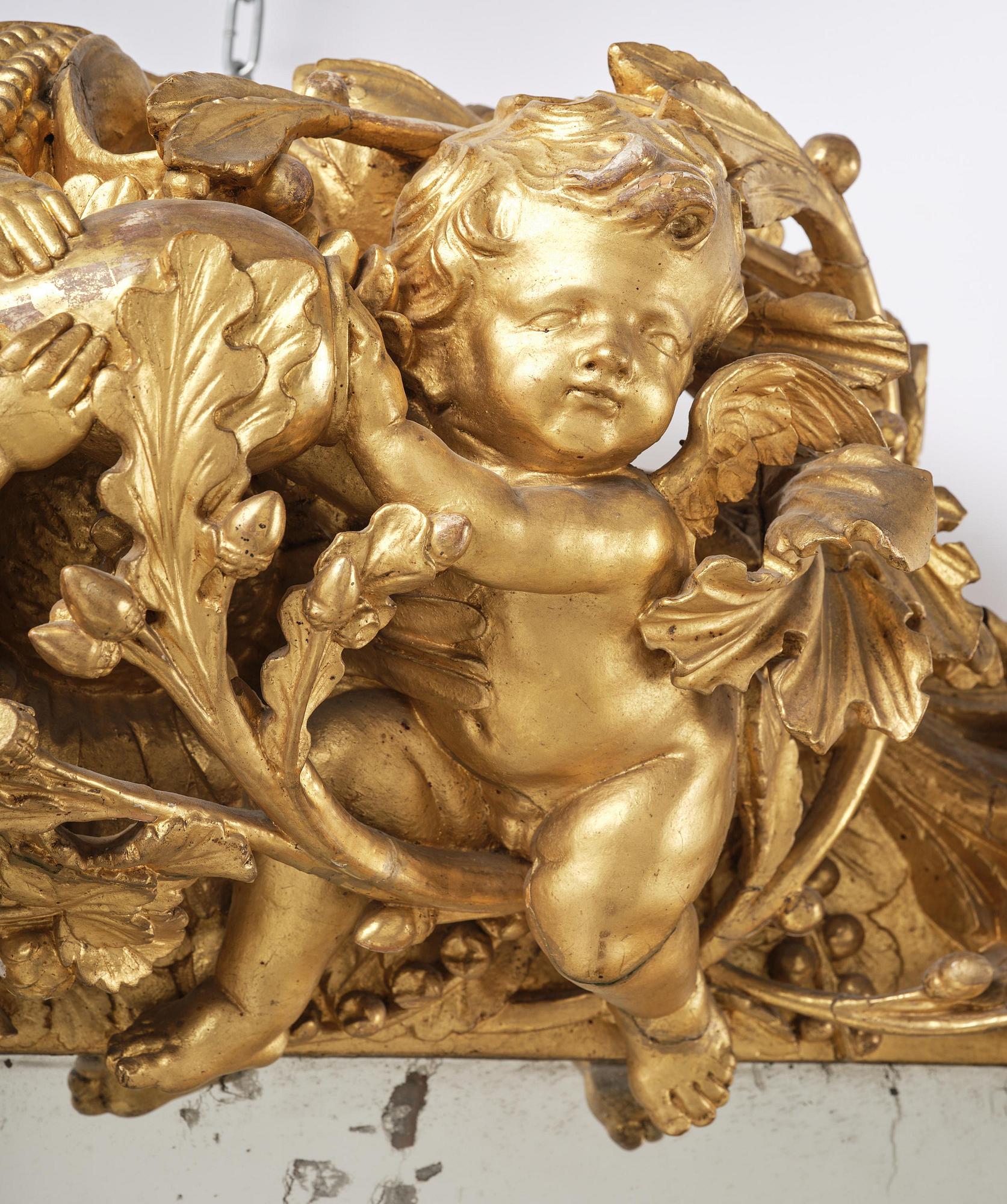 A presumably Dutch Louis XIV carved giltwood frame with mirror glass, in the style of Jean Le Pautre, late 17th century.