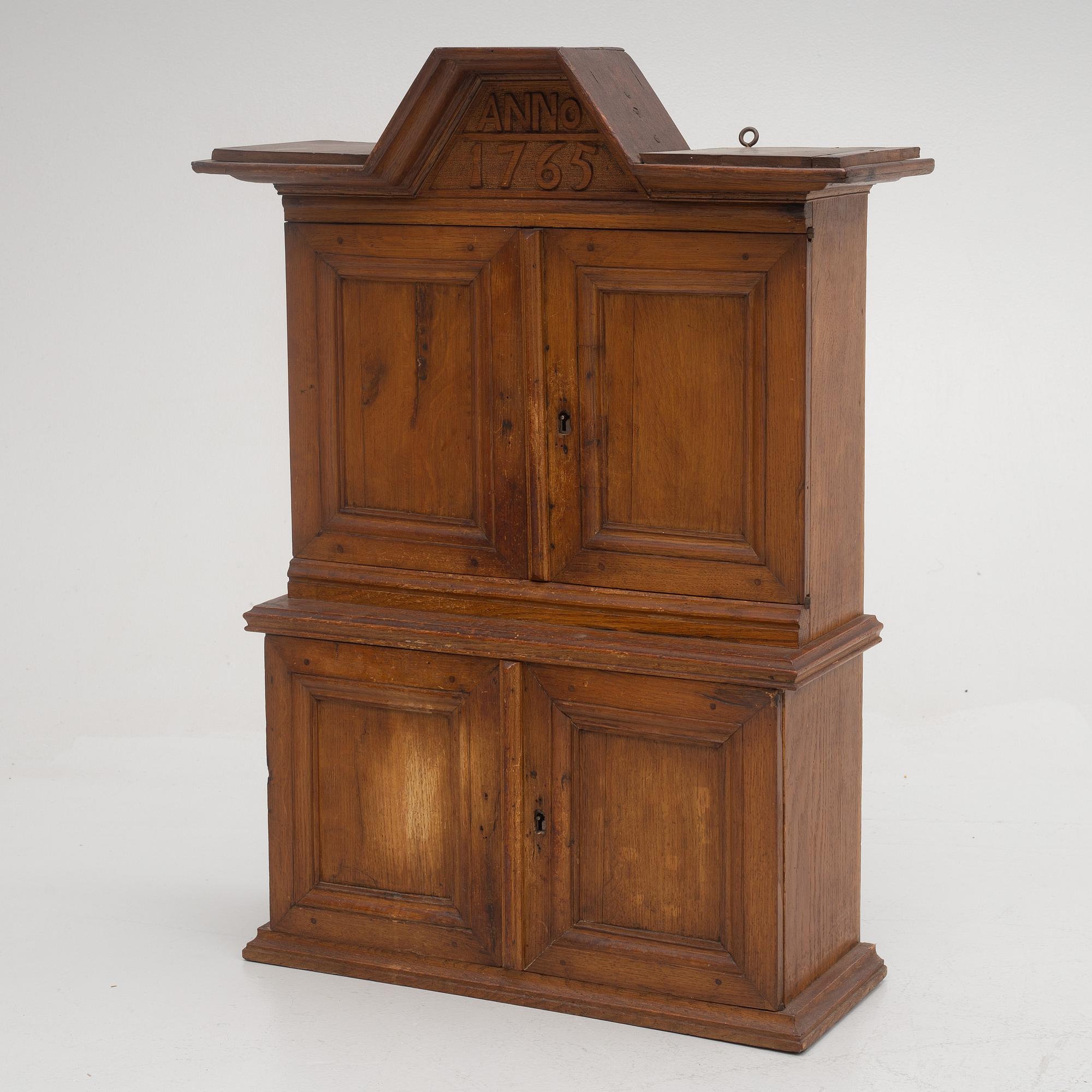 A wall cabinet, dated 1765.