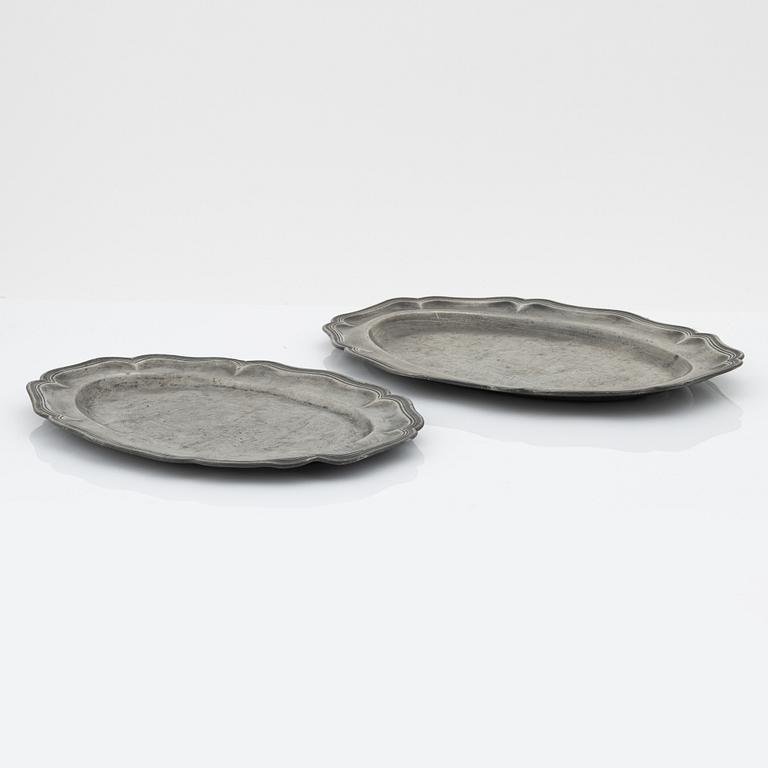 A set of six rococo pewter trays, mid 18th Century.