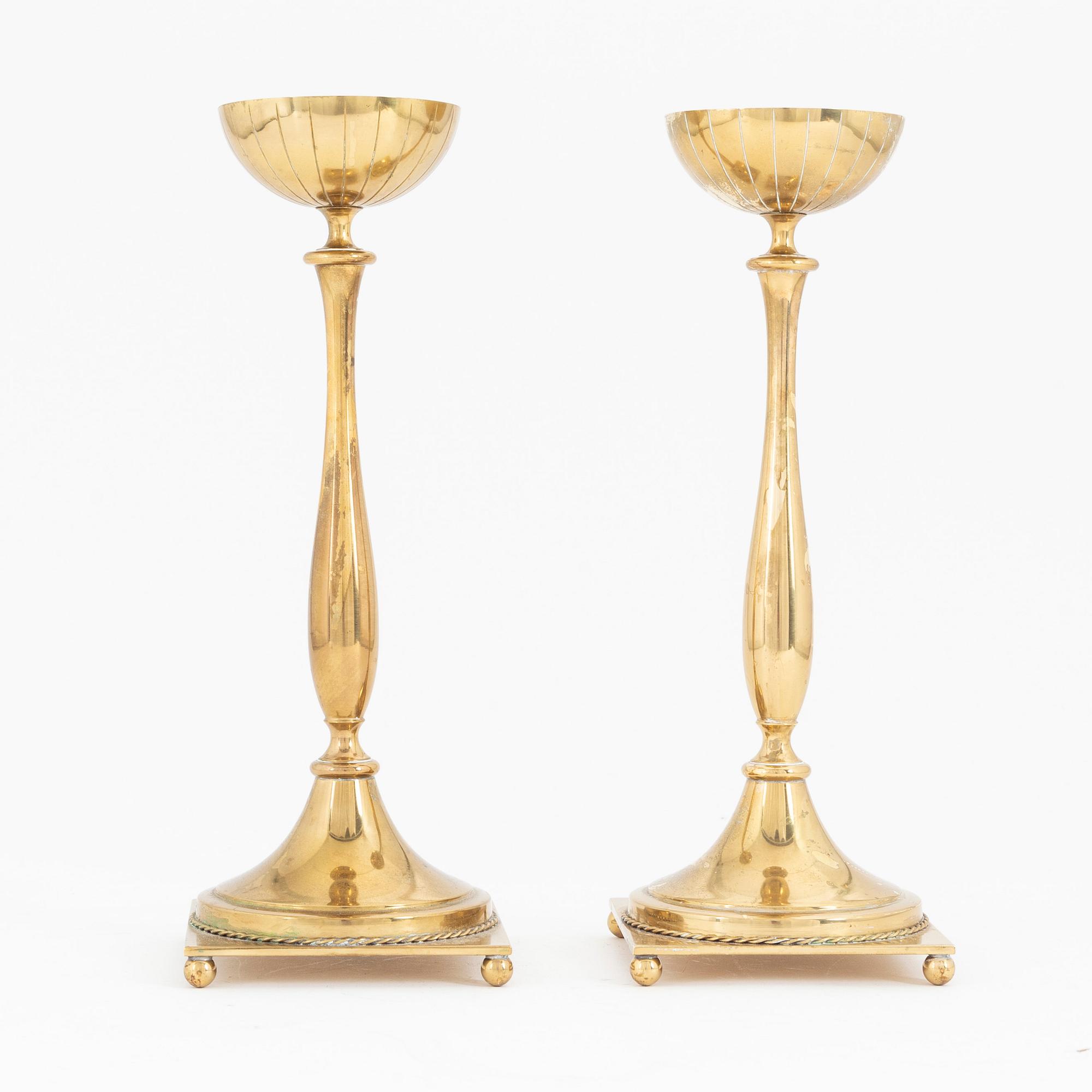 Gunnar Ander, a pair of brass candlesticks, Ystad metall, mid 20th Century.