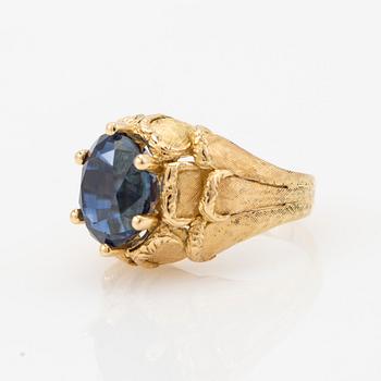Ring, 18k gold with blue stone, possibly sapphire.