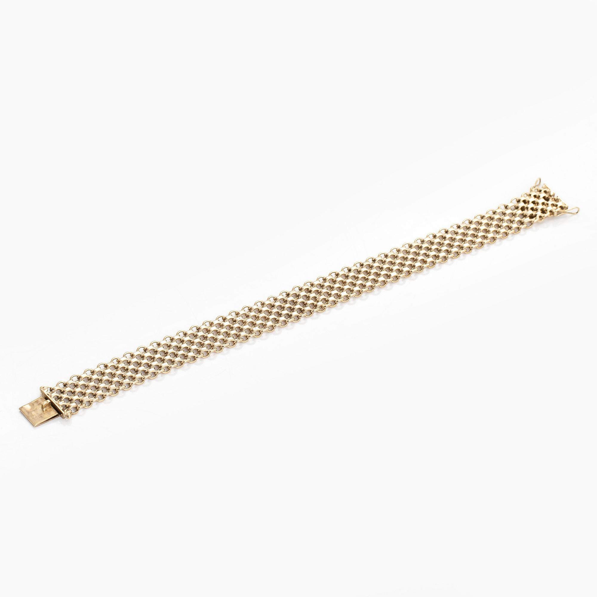 A 14K gold X-link bracelet, likely Norway.