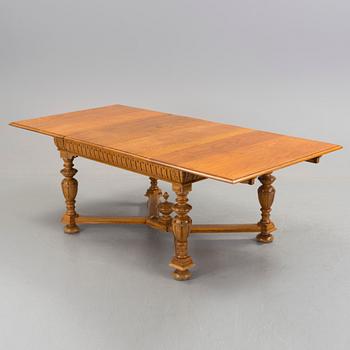 An oak Baroque-style dining table, around 1900.