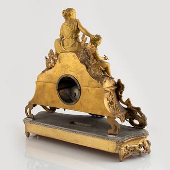 A table clock and a pair of candelabras, Louis XVI-style, France, beginning of the 20th century.