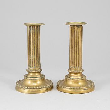 A pair of Louis Seize bronze candlesticks.