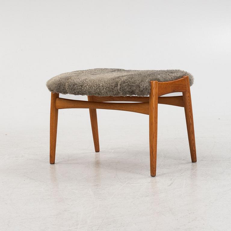 An sheepskin upholstered oak stool, mid 20th Century.