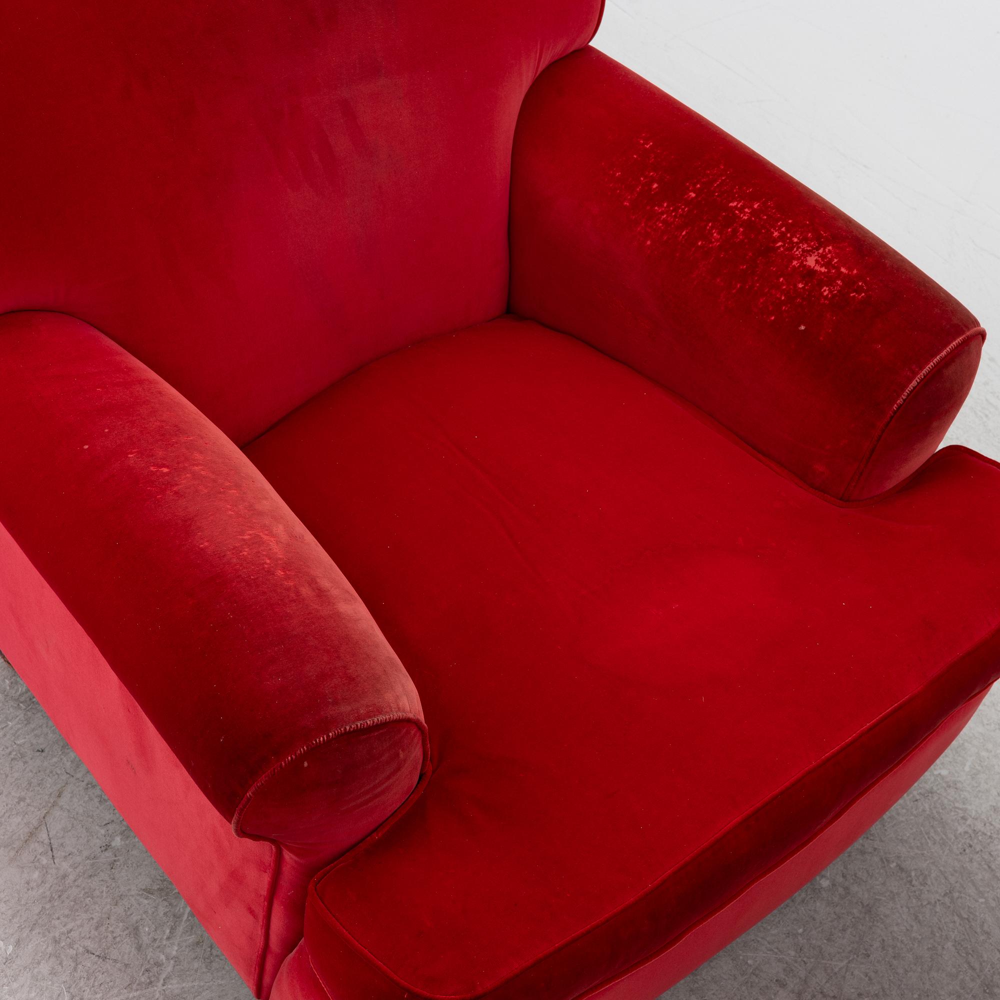 A pair of Howard-style armchairs and a footstool, late 20th century.