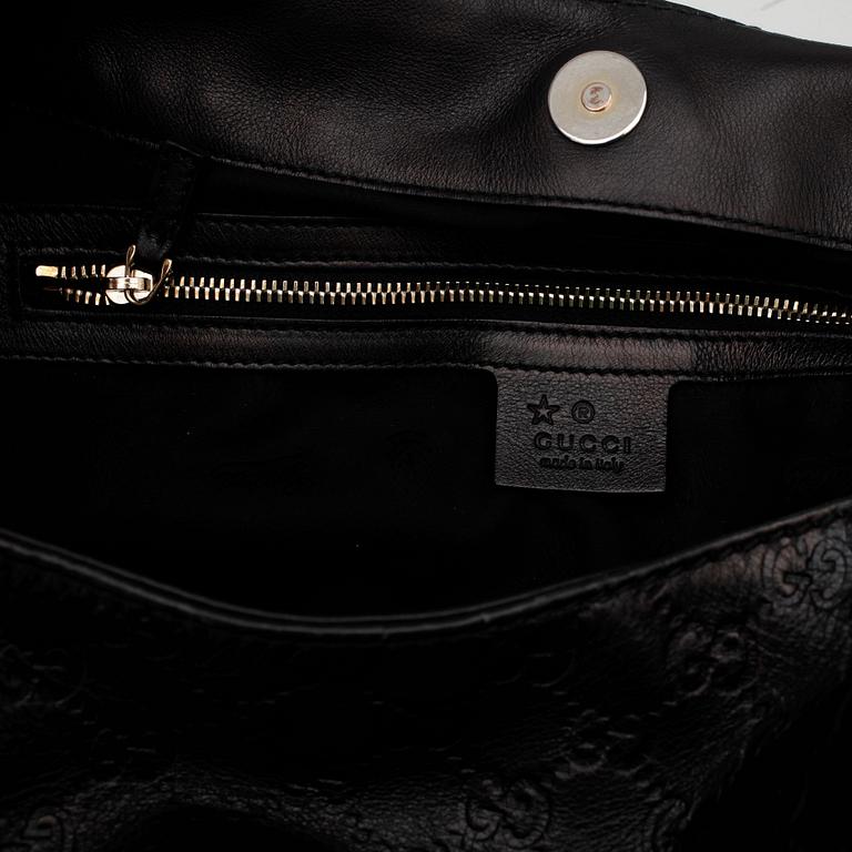 GUCCI, a black monogrammed leather shoulder bag.
