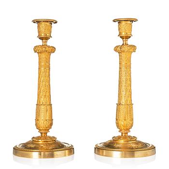 A pair of French Empire candlesticks.