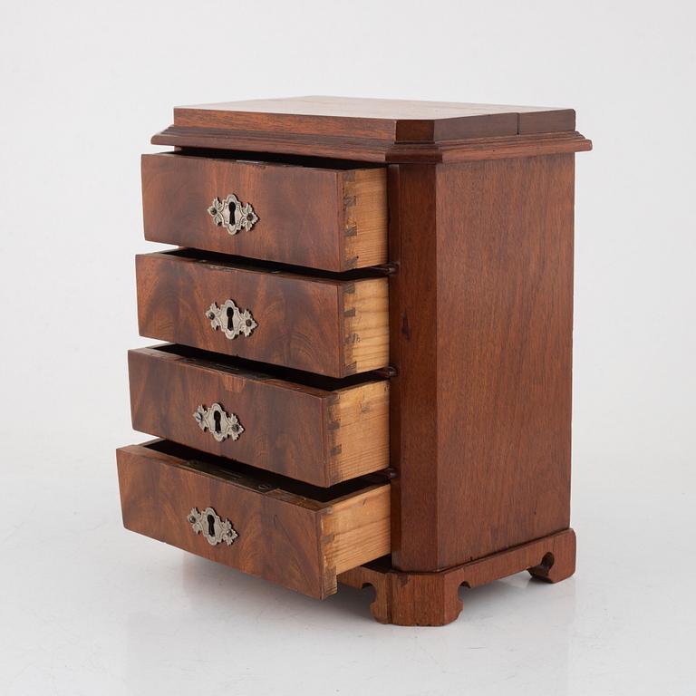 A mahogany miniature commode, later part of the 19th century.