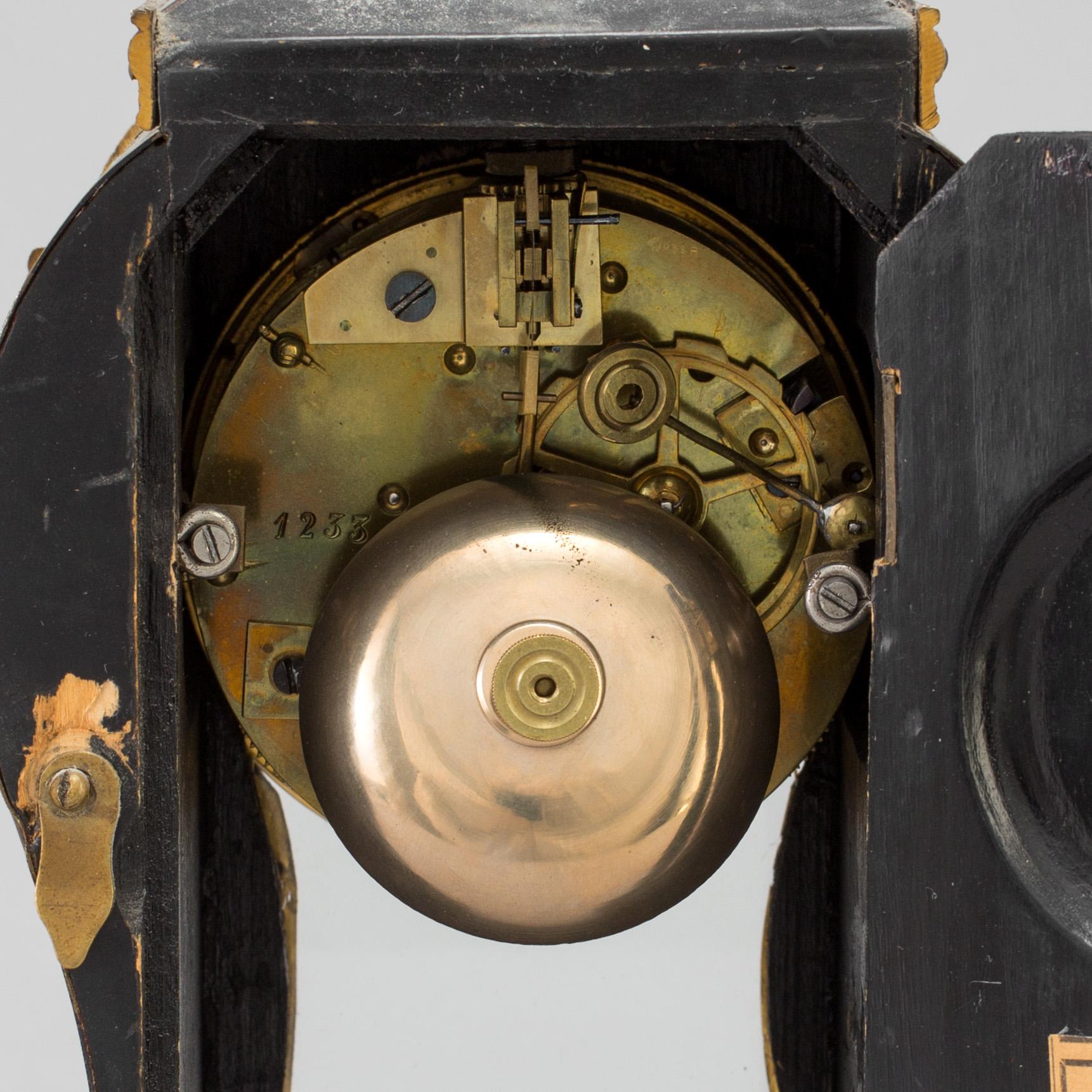 A Louis XV-style mantle clock with console base.