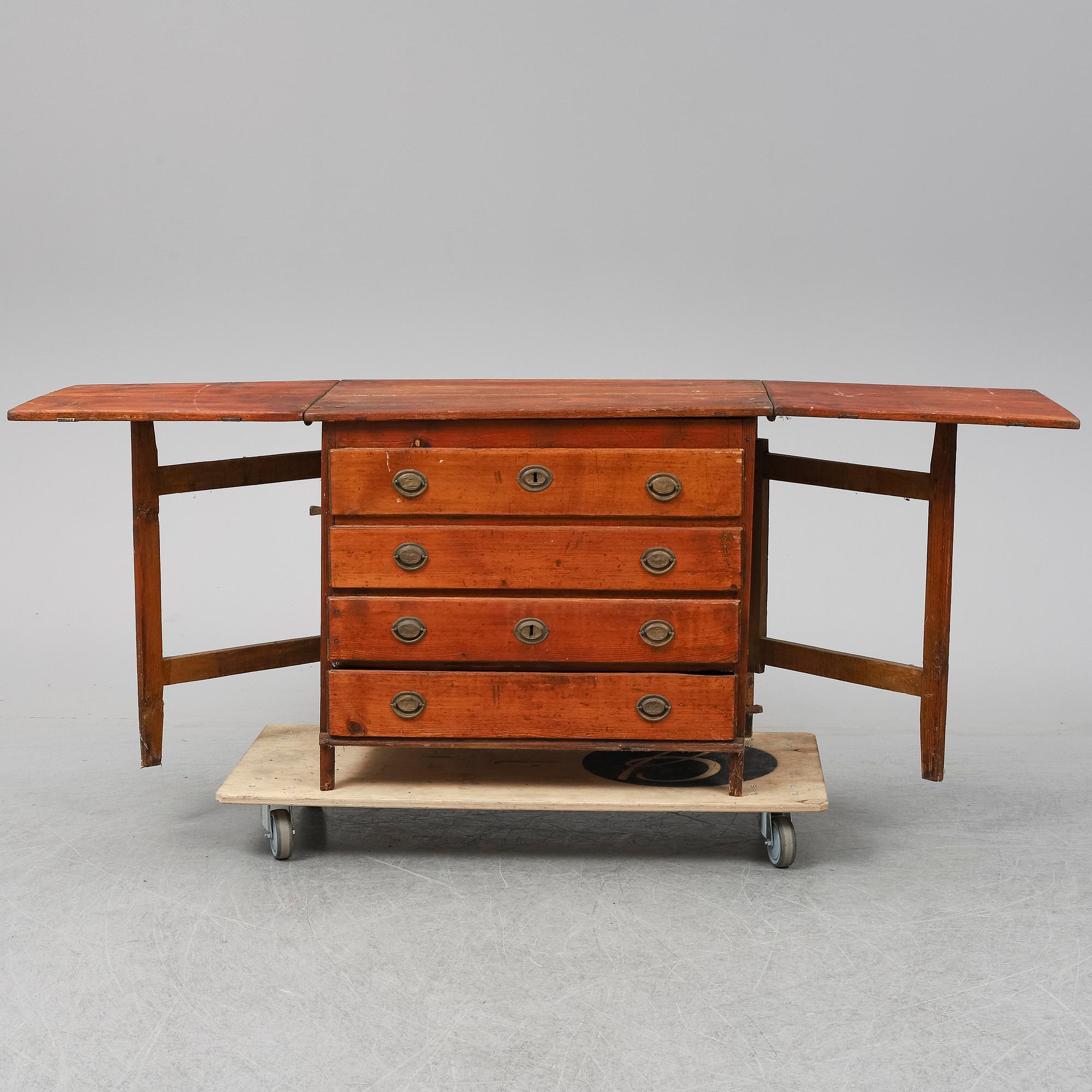 A 19th Century chest of drawers with a table top.
