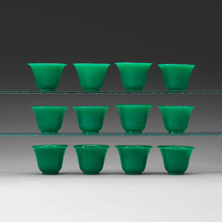 A set of 12 green peking glass wine cups, late Qing dynasty (1644-1912).