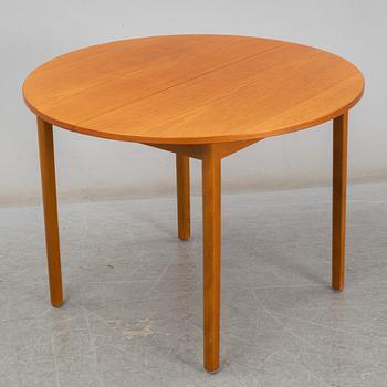 A second half of the 20th century teak veneered dining table.