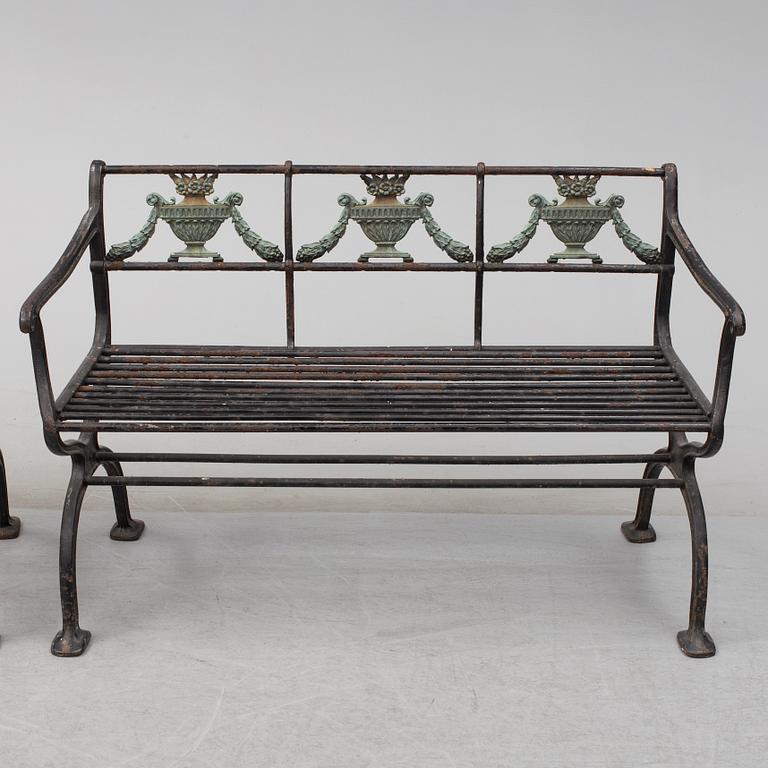 GARDEN SOFAS, a pair, cast iron, empire style, late 19th century.