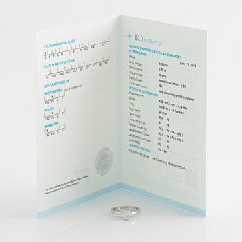 An 18K white gold ring set with a round brilliant-cut diamond.