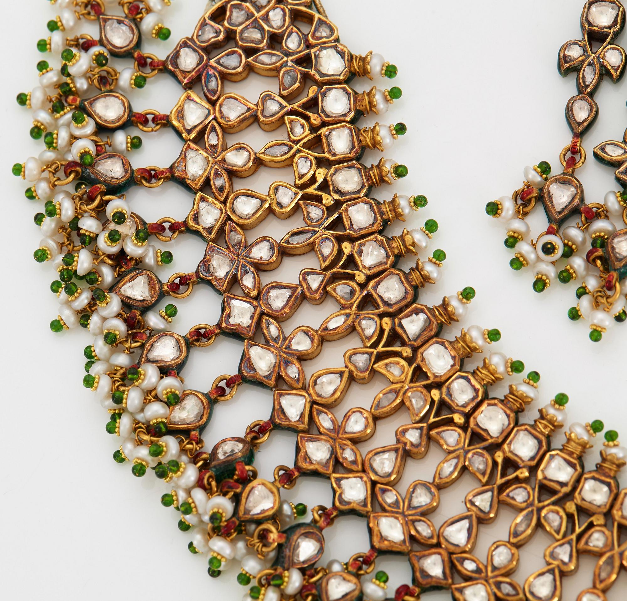 An Indian demi parure comprising a necklace and a pair of earrings.