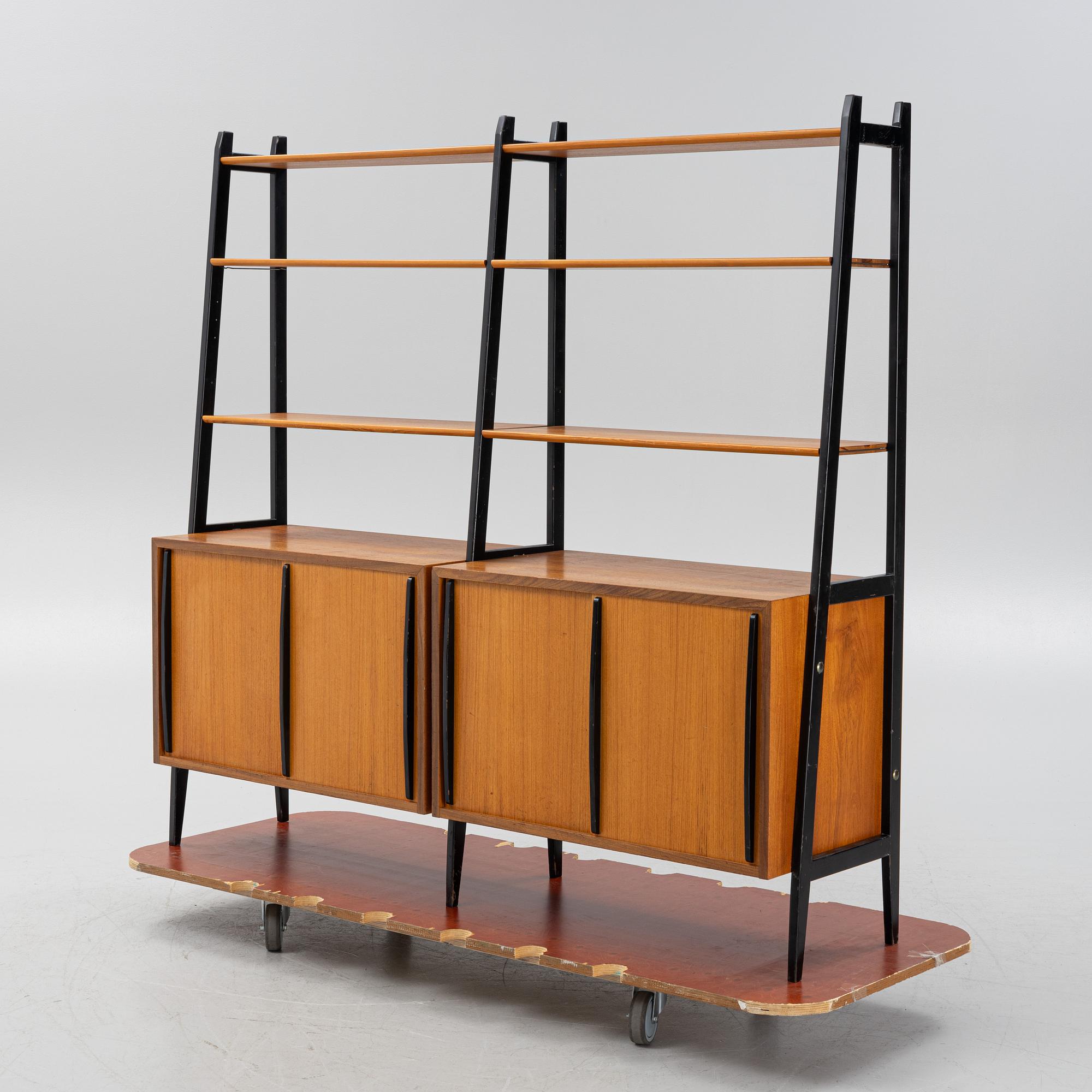 Teak veneered book cases with cabinets.