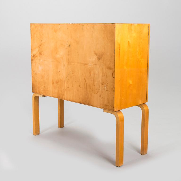 Alvar Aalto, mid-20th century '810' cabinet and a 
'69'chair Oy Huonekalu- ja Rakennustyötehdas Ab.