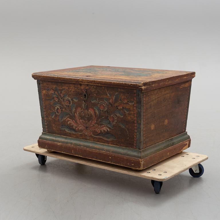 A painted pine chest from Bjuråker, Hälsingland, dated 1828.