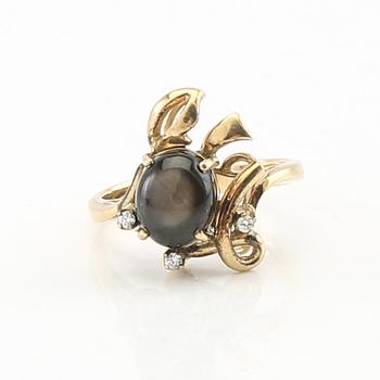 Ring and earrings in 14K gold with round brilliant-cut diamonds and likely natural black star sapphires.