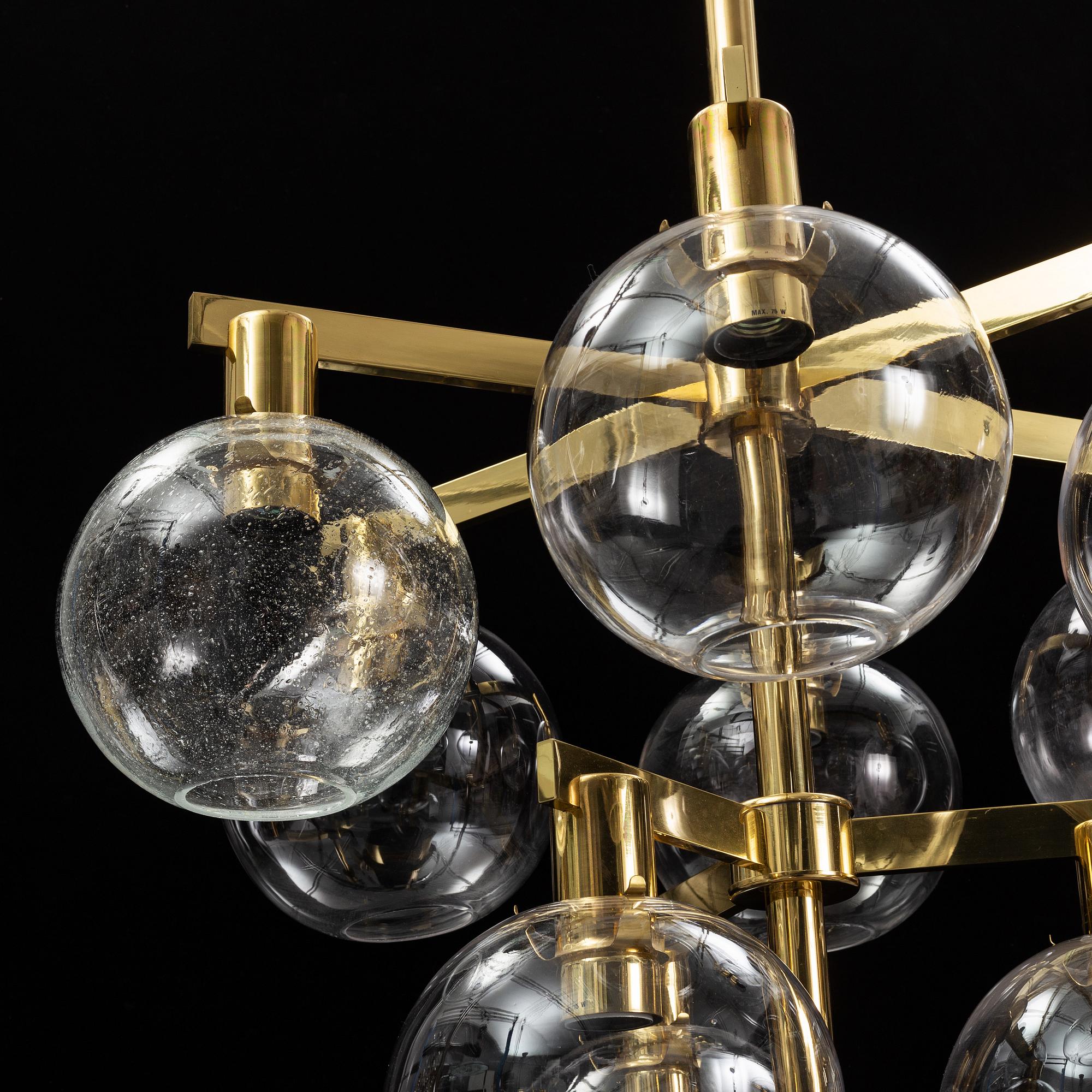 A brass chandelier with glass globes by Hans Agne Jakobsson, Markaryd.